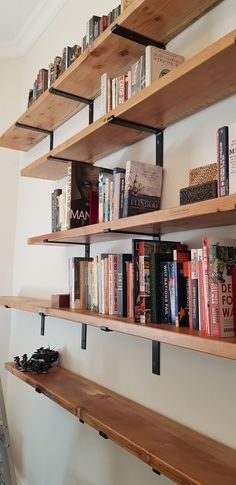 some books are sitting on shelves in a room