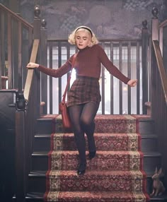 a woman in tights is walking down the stairs with her hands on her hips