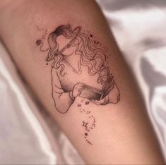 a woman's arm with a tattoo on it that has a drawing of a girl drinking from a cup