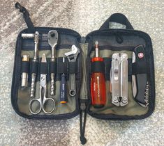 an open tool bag with various tools in it