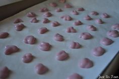 the dough is covered in pink icing and sprinkled with white frosting