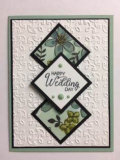 a handmade wedding card with flowers and leaves on the front, in white background