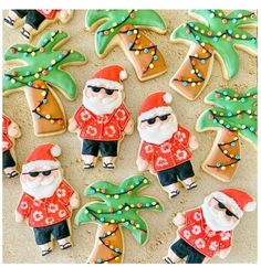 decorated cookies with santa clause and palm trees on the beach in front of people wearing sunglasses