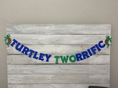 there is a sign that says turtley twotrig on the wood planks