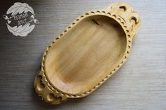 an oval wooden tray with holes in the middle