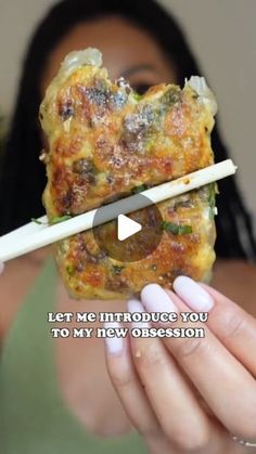 a woman holding a piece of food with chopsticks in her hand and the words let me introduce you to my new obsession