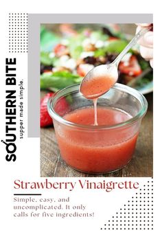 strawberry vinaigrete is being poured into a glass bowl with a spoon in it