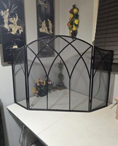 an iron bed frame sitting on top of a white desk