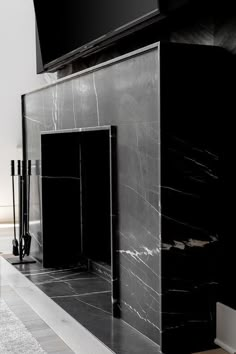 a large black marble fireplace in a living room