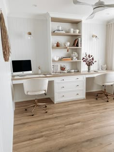 a home office with white furniture and wood floors