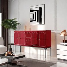 a living room filled with white furniture and red cabinet in the middle of the room