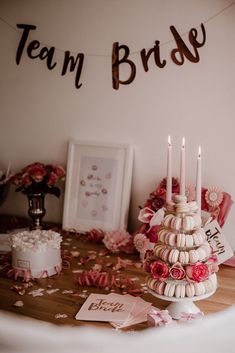 a table topped with a cake covered in macaroons