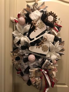 a christmas wreath made out of shoes and other holiday decorations hangs on the front door