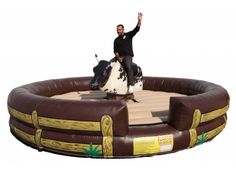 a man riding on the back of a horse in an inflatable ring