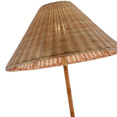 an umbrella made out of wicker with a wooden pole on the top and bottom