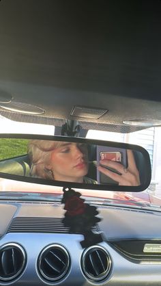 a rear view mirror reflecting a woman's face