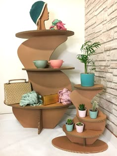 three tiered shelves with pots and plants on them