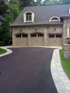 a large house with two garages on the front and one car in the driveway