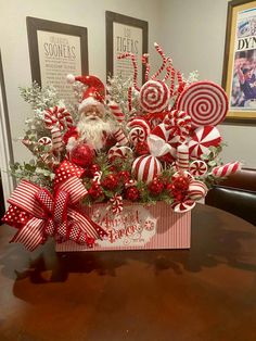 a christmas centerpiece with candy canes and santa clause