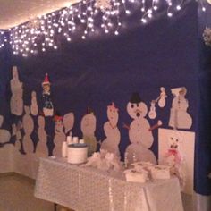 a table covered in snowmen and other decorations