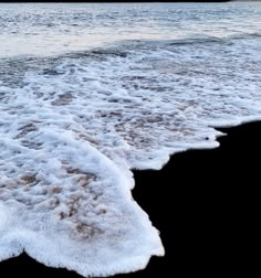 an ocean beach with waves coming in to shore