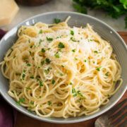 a bowl filled with pasta and parmesan cheese