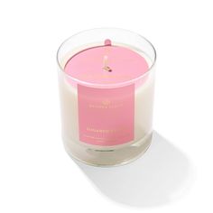 a pink candle sitting on top of a white table