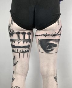 a person with tattoos on their legs and leggings that have an image of a man's face behind barbed wire