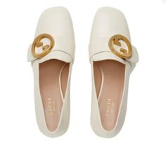 These Pristine Preloved Gucci Blondie Pumps Seamlessly Integrate Elegance Into Practicality. Made In Italy, These Slip-On Pumps Present A Cream Leather Exterior And Resemble A Pair Of Loafers. Each Vamp Is Adorned With The "Blondie" Interlocking Gold-Tone Logo Buckle, And Feature A Beveled Square-Toe Silhouette; Paying Homage To The Brand's Archives From The Seventies. The Tonal Covered Block Heel Guarantees Comfort And Subtle Height. Pair These Luxury Pumps With A Neutral Blazer, Tailored Pants, And Your Gold Jewelry To Perfectly Capture The Retro Feel. Box And Dust Bag Included See Photos For Protective Sole Added By Shoemaker To Extend The Life Of The Shoe Neutral Blazer, Gucci Beige Bags With Silver-tone Hardware, Gucci Heels With Gold-tone Hardware For Evening, Gucci Business Bag With Gold-tone Hardware, Luxury Gucci Heels With Gold-tone Hardware, Gucci Beige Bags With Gold-tone Hardware, Slip On Pumps, The Seventies, Tailored Pants