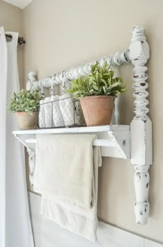 a towel rack with two plants on it