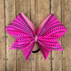 This gorgeous bow is new for the  2024 season!  Shown in pink with high facet black stones and is available in any fabric/stone color.   Badda Bling Bows provides the highest quality bows on the market specializing in individual, practice and team bows and we uniform match.   - FREE SHIPPING on all team orders. - Made with 3" ribbon and premium nylon elastic hair bands that won't damage hair as they have no metal parts and are seamless. - Packaged and shipped in a box to ensure it arrives in perfect condition. Follow us on: FACEBOOK: https://www.facebook.com/baddablingbows INSTAGRAM: @baddablingbows TIKTOK: baddablingbows If you are placing an order as a sample for a team, please message us prior to see if we can accommodate you.  Orders with a "need by date" cannot be guaranteed as we tak Competition Bows, Bling Bows, Damage Hair, Bow Ideas, Merritt Island, Black Stones, Cheer Bow, Rhinestone Bow, Cheer Bows