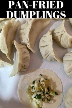 some dumplings are sitting on top of a white tablecloth with the words pan - fried dumplings above them