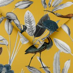 a yellow wallpaper with birds and leaves on it