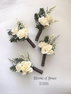 three bouquets of white flowers and greenery are arranged in the shape of boutions