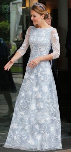 the princess is wearing a blue dress with white flowers on it