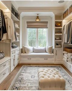 a walk in closet filled with lots of white furniture and shelves full of clothes on top of them