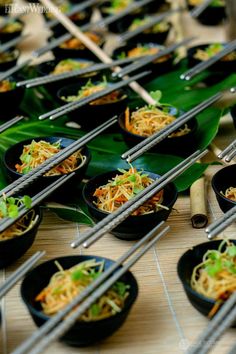 many bowls filled with food sitting on top of a table