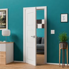 an open door in a living room with teal walls and wood flooring on the side