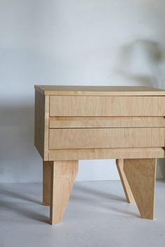 a wooden table with two drawers on it