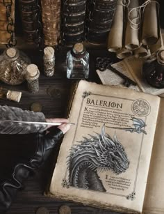 an old book sitting on top of a wooden table next to bottles and other items