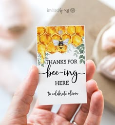 a person holding up a card that says thanks for bee - ing here to celebrate