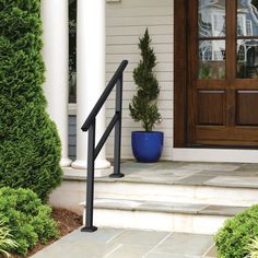 a blue planter sitting on the side of a house next to a black metal hand rail