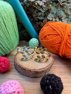 several balls of yarn and crochet are sitting on a table next to each other