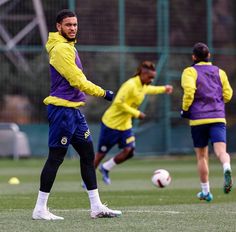 soccer players in action on the field during a training session with one player about to kick the ball