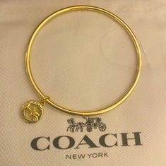 Nwot New Never Used. Coach Horse And Carriage Bangle Bracelet W Charm Coach Bangle Bracelet With Charm. Charm In Gold Over Brass! Comes In Black Unbranded Box. Perfect For The Coach Collector! Card And Dust Bag Is For Pic Purposes Only. Coach Metal Bangle Jewelry, Adjustable Jewelry With Logo Charm As Gift, Coach Gold Bangle Bracelet, Coach Bracelets As Gift, Coach Adjustable Bangle, Everyday Gold Coach Jewelry, Adjustable Coach Bangle, Adjustable Logo Charm Bracelet, Adjustable Yellow Gold Bracelet With Logo Charm