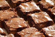 brownies with frosting sitting on top of a table