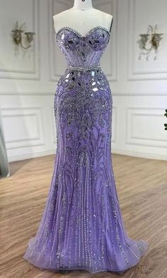 This gown showcases a strapless design with a sweetheart neckline, emphasizing a classic and timeless silhouette. The entire dress is embellished with mirror, rhinestones and beads, creating a stunning and dazzling effect as it catches the light. This gown exudes elegance and sophistication, making it an ideal choice for formal events or glamorous occasions. Production time is between approx 6-7 weeks. * Sizing - All items are made according to measurement ranges, they are NOT typical letter or numeric sizing. It is imperative to compare your exact measurements with the size chart provided either in the listing photos or item descriptions and to also add your measurements under Personalization. If you have any questions on sizing, please feel free to message me. Do not order your normal si Sparkling Sweetheart Neckline Gown For Prom Season, Sparkling Sweetheart Neckline Gown For Prom, Embellished Strapless Evening Dress For Debutante Ball, Rhinestone Gown For Debutante Ball And Prom Season, Purple Embellished Evening Dress With Sweetheart Neckline, Floor-length Rhinestone Gown For Debutante Ball, Formal Evening Dress With Rhinestones And Sweetheart Neckline, Glamorous Gown With Rhinestones For Debutante Ball, Glamorous Rhinestone Gown For Debutante Ball