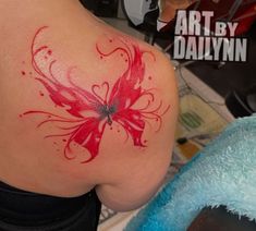 a woman with a red tattoo on her back