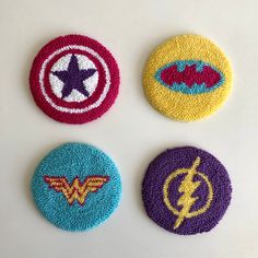 four crocheted coasters with different logos on them