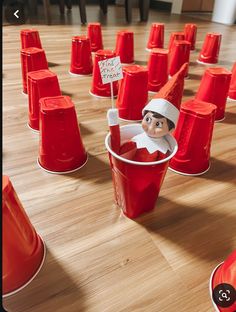 an elf in a bucket surrounded by red cones